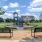 a playground with benches and a slide