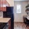 a kitchen with a black refrigerator