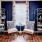 a room with a blue wall and white furniture